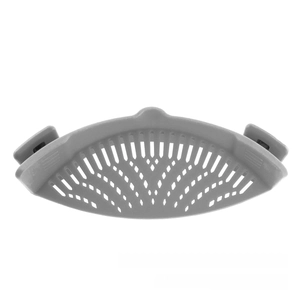 Close-up of gray silicone pot strainer showing the clip-on design and drainage holes
