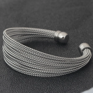 Detail of multi-layer silver twisted cable cuff bracelet with round bead end caps