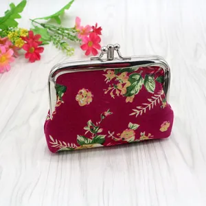 Detail of vintage floral canvas coin purse with classic silver kiss-lock clasp closure