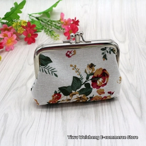 Close-up of vintage floral canvas coin purse with classic silver metal clasp closure