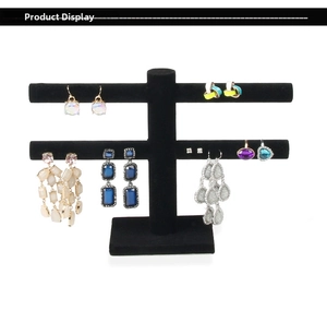Detail of two-tier black velvet jewelry stand showcasing earrings and rings clearly