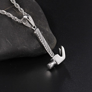 Creative titanium steel hammer pendant necklace on a dark stone surface for men