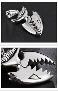 Detailed macro view of silver crocodile teeth pendant in punk stainless steel style