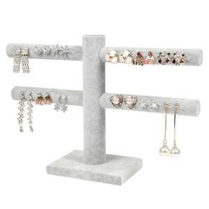 Two-tier gray velvet jewelry stand for earrings with stable base on white background