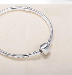 Detailed close-up of 3mm silver snake chain bracelet with classic barrel clasp design