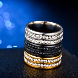 Macro detail of three-color stainless steel rings with double-row sparkling crystals