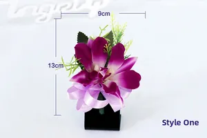 Detailed close-up of a purple faux orchid boutonniere with a lavender ribbon bow