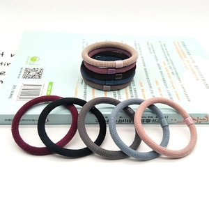 Close-up of high elasticity woven hair ties in various colors with decorative plastic buckles