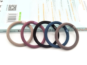 Detailed view of 5-pack high elasticity woven hair ties in assorted earthy tones