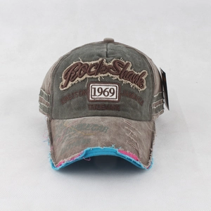 Close-up of vintage washed canvas baseball cap with 1969 Rock Shank embroidery and worn edges