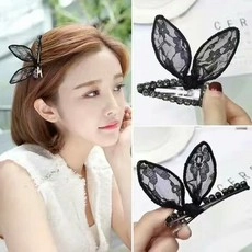 Detail of black lace rabbit ear hair clip with pearl beads and metal duckbill base