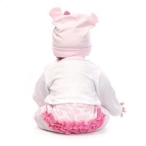 Rear view of lifelike baby doll wearing a pink heart-patterned outfit and hat