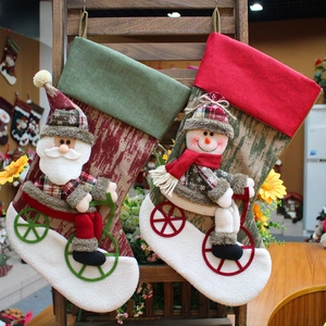 Linen Christmas stockings with Santa and snowman on bikes hanging for holiday decor