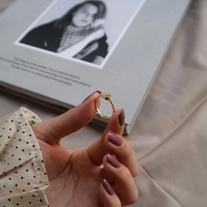 Detailed view of a gold-plated sterling silver cat's eye stone ring with twisted band