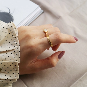 Detailed view of gold S925 silver ring with white cat eye stone and V-shaped texture