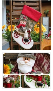 Detail of red plaid Christmas stocking featuring a 3D snowman riding a bicycle