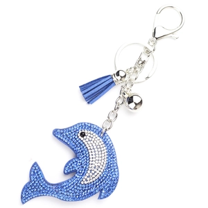 Close-up of blue rhinestone dolphin keychain with leather tassel and polished metal bell