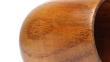 Close-up of a carbonized wooden cup showing natural grain texture and heat-proof design
