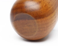 Detailed close-up of the smooth rounded base and natural grain of the wooden cup