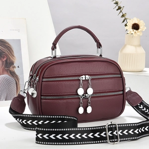 Burgundy lychee pattern leather handbag with triple zipper and geometric wide strap
