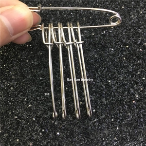Macro detail of polished silver metal safety pin set for scarves and DIY apparel