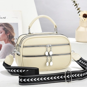 Chic beige textured faux leather handbag with wide woven strap and zippered pockets