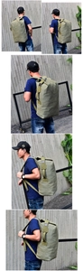 Outdoor shot of large army green canvas travel backpack worn by a model on a urban street
