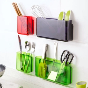 Wall-mounted kitchen organizers in multi-colored translucent plastic on white tiles