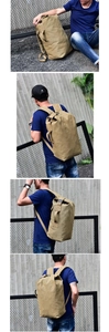 Detail of khaki canvas backpack with roll-top design and adjustable straps in urban setting