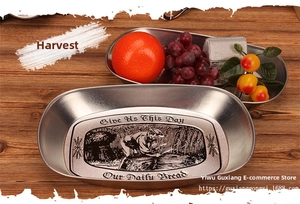 Detail of vintage oval stainless steel tray featuring engraved farmhouse bread pattern