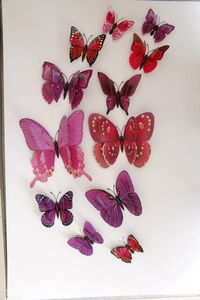 Flat lay of 12 mixed-size 3D double-layer butterfly wall stickers in red and purple