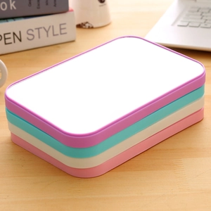 Foldable square desktop vanity mirrors in purple, cyan, white and pink on wooden desk