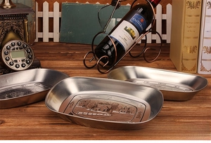 Detailed view of three vintage boat-shaped tin plates with landscape coffee engravings