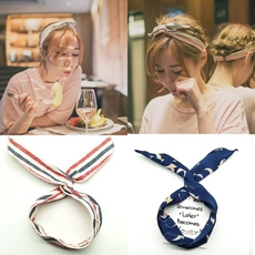 Detail of red striped and blue moon pattern velvet hair scrunchies on model and flat lay