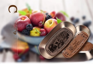 Close-up of vintage boat-shaped tinplate tray with embossed floral patterns and fruits