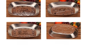Detailed macro view of vintage boat-shaped tin fruit trays with embossed pastoral patterns