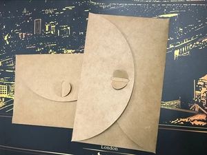 Close-up of 300g kraft paper envelopes featuring unique heart-shaped clasp closures