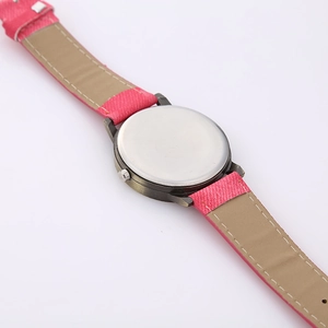 Macro shot of pink fabric watch strap with beige inner lining and stainless steel back