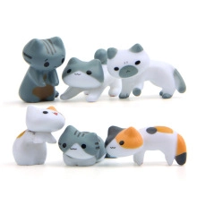 Detailed macro view of six diverse miniature resin cat figurines with realistic fur patterns