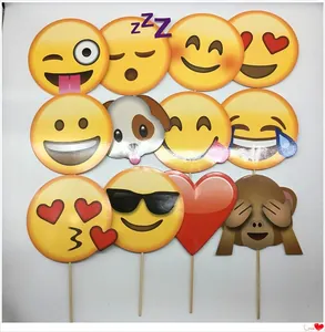 Detailed view of 12 unique Emoji photo props on wooden sticks for parties and events