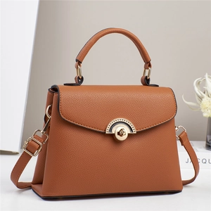 Caramel lychee grain leather handbag with gold wavy buckle and adjustable shoulder strap