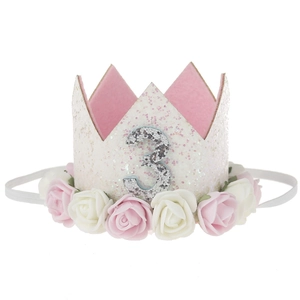 Detail of pink birthday crown headband with number 3 and decorative foam flowers