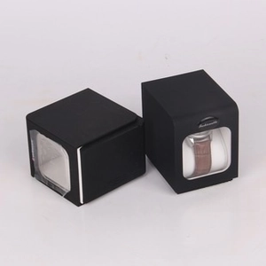 Detail of matte black square watch box with transparent window and soft watch cushion