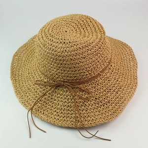 Handwoven wide brim raffia sun hat with bow detail for summer outdoor vacation