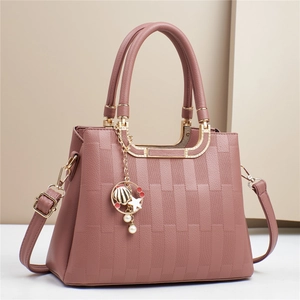 Elegant dusty pink crossbody bag with geometric texture and star shell charm detail
