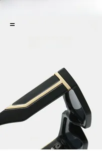 Detail of golden T-shaped metal hinge on sleek black square frame sunglasses