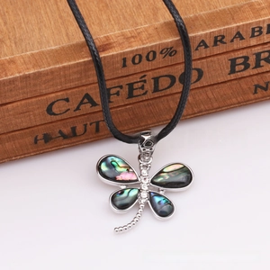 Detail of dragonfly necklace featuring natural abalone shell inlay and zircon accents