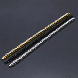 Three men's 5mm iced out tennis bracelets in gold, silver, and black on a reflective surface