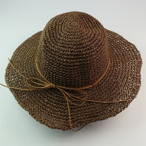 Deep brown raffia wide brim sun hat with ribbon bow decoration for summer beach travel