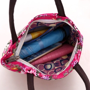 Spacious floral canvas tote bag showing interior with umbrella, phone, and wallet